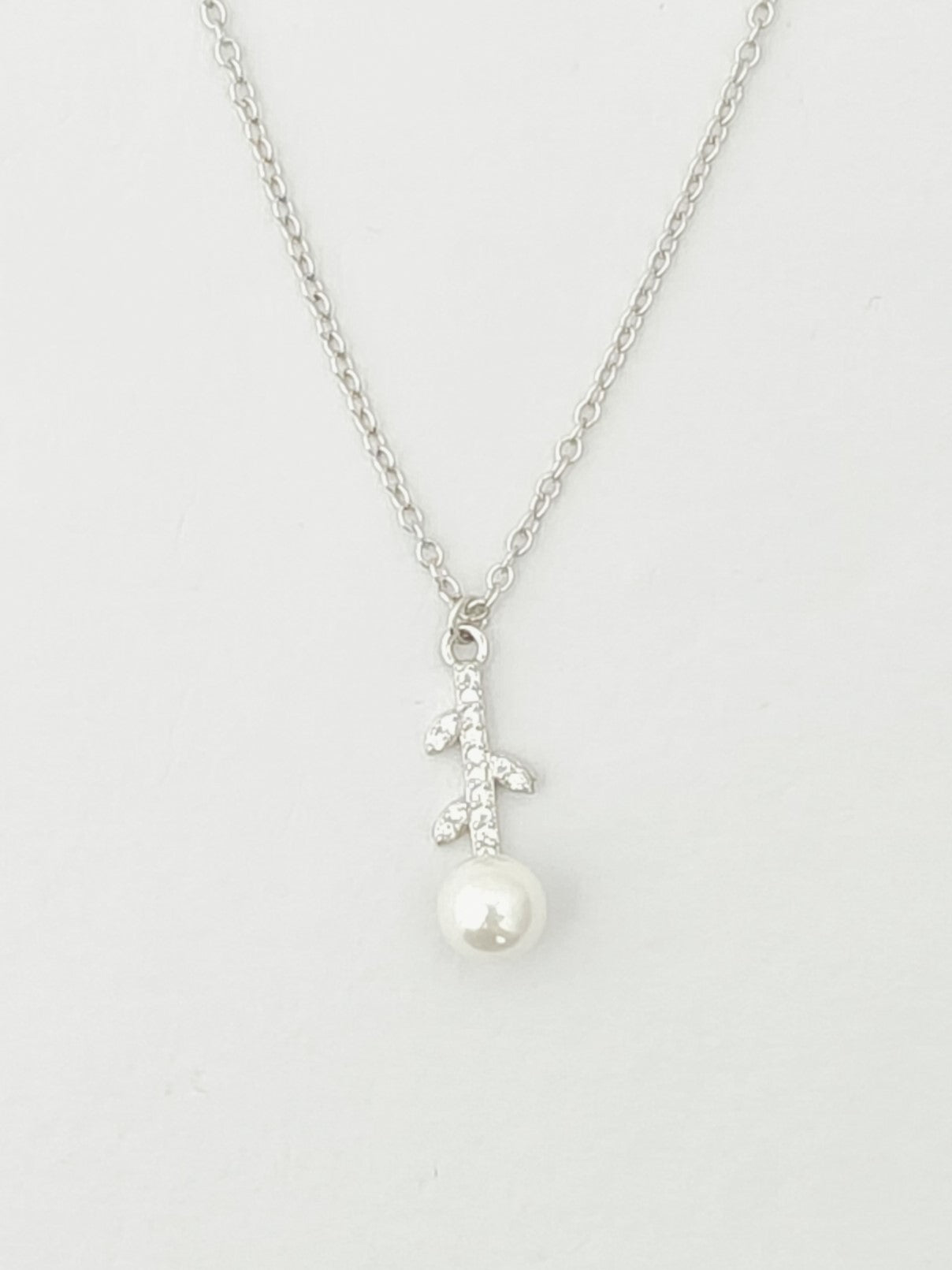 Pearl necklace with silver chain on a white background